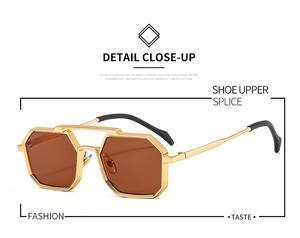 Close-up of golden geometric polygonal sunglasses with high-quality dark amber lenses