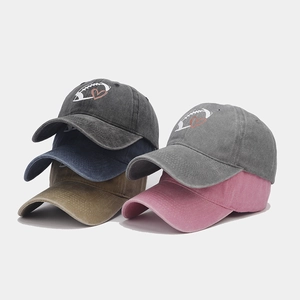 Detail view of cotton baseball caps in four colors featuring heart and rugby embroidery