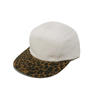 Detail view of retro five-panel baseball cap with white crown and leopard print brim