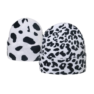 Winter knitted beanie hats featuring cow print and leopard patterns in black and white