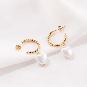 Boucles d'oreilles créoles torsadées dorées avec d'élégants pendentifs perles en cœur
