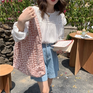 Detail of pink floral lace tote bag featuring 3D textures and casual summer style