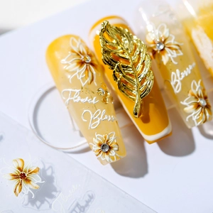 Floral nail art stickers with yellow gradient base and 3D gold leaf embellishments