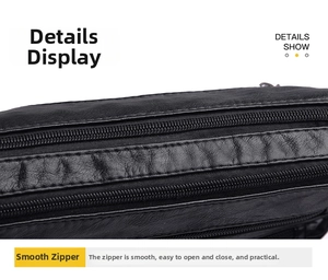 Detail of smooth double metal zippers and textured black washed leather on shoulder bag