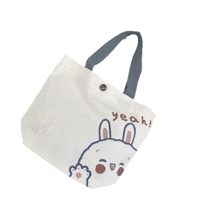 Cute canvas tote bag with white bunny print and red yeah text on cream background