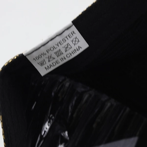 Close-up of cotton baseball cap care label showing 100% polyester fabric and washing symbols