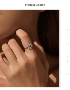 Detailed close-up of a silver heart-shaped ring with pavé diamonds on a model's finger
