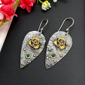 Vintage golden flower earrings with green crystals and textured silver waterdrop design
