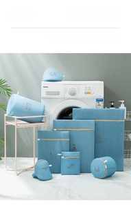 Blue mesh laundry bag set with embroidered clothing icons and gold metal zippers