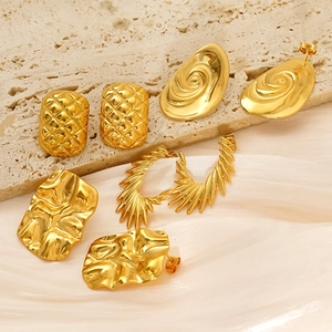Set of four pairs of gold titanium steel earrings with irregular geometric wing patterns