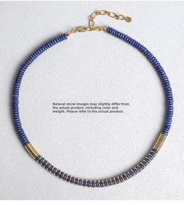 Detail view of natural lapis lazuli beads with gold spacers and lobster clasp chain
