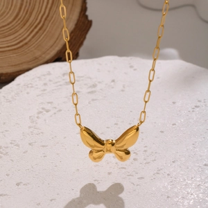 Polished butterfly pendant necklace in 18K gold plated stainless steel on stone