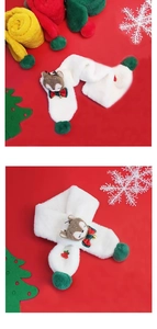 Close-up of white plush Christmas scarf with cartoon reindeer and colorful pompom detail