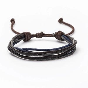 Close-up of vintage multi-layer braided leather bracelet with adjustable pull-string knot
