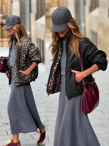 Detail view of reversible jacket featuring leopard print and solid black fabric lining