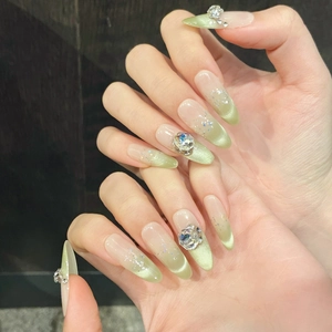 Cat eye gradient green press-on nails with sparkling rhinestones in almond shape