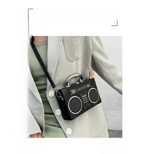Detailed view of a creative retro radio-shaped crossbody bag with silver metal handle