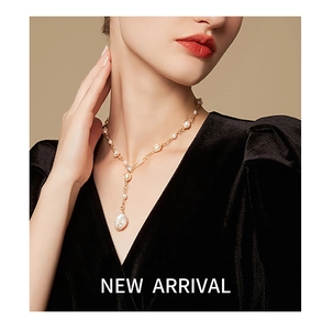 Elegant detail of baroque freshwater pearl necklace with gold chain and shell pendant