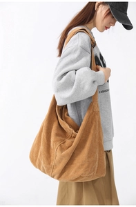 Brown corduroy tote bag showing large capacity and soft texture on female model