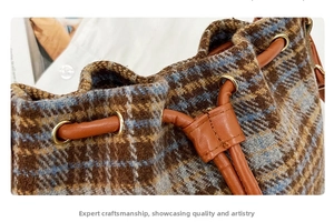 Detail of checkered wool bucket bag featuring brown leather drawstring and gold metal buckle