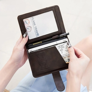 Brown leather RFID blocking passport wallet with internal slots for cards and pen