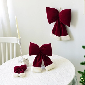 Festive red velvet Christmas bows with white faux fur trim in various sizes for decor