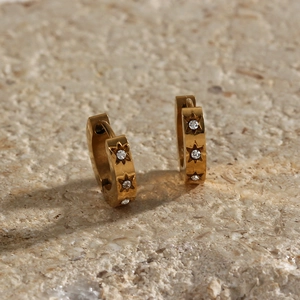 Detailed macro of 18K gold plated stainless steel hoop earrings with star zirconia