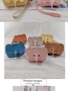 Detailed view of elephant shaped coin purses in various colors on a plush white surface