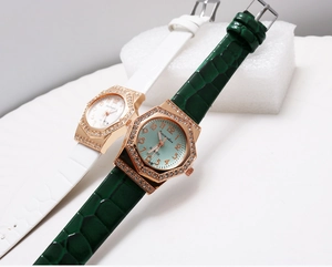 Detail of octagonal quartz watches with rhinestone bezel and crocodile embossed leather strap