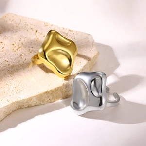 Macro detail of irregular lava texture square rings in gold and silver finish