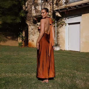 Detailed back view of a satin halter maxi dress featuring backless cut and side slit
