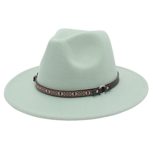 Detail of mint green wool fedora hat featuring ethnic patterned band and silver buckle