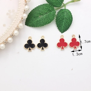 Macro view of club-shaped DIY charms in black and red enamel with size measurements