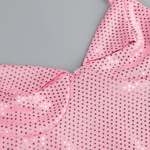Gros plan sur le tissu à pois roses avec paillettes argentées et coutures détaillées