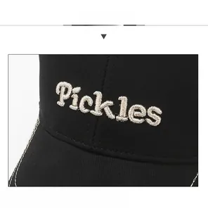 Close-up of Pickles embroidery and white contrast stitching on a black baseball cap