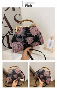 Detail of pink embroidered peony flowers and wooden handle on a vintage black handbag