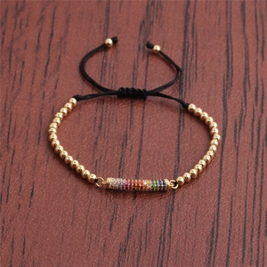 Adjustable black cord bracelet with golden beads and rainbow cubic zirconia centerpiece