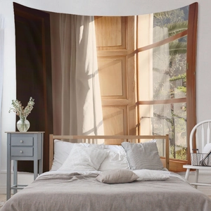 Detail showing the sunlit window and white curtain pattern on a bedroom wall tapestry