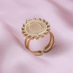 Detail view of gold stainless steel adjustable ring with sunburst oval tray design