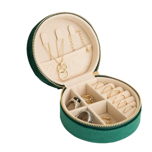 Portable round dark green velvet jewelry box with golden zipper for rings and necklaces
