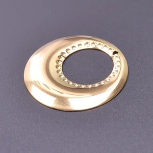 Macro detail of 18k gold plated stainless steel ring component with textured inner edge
