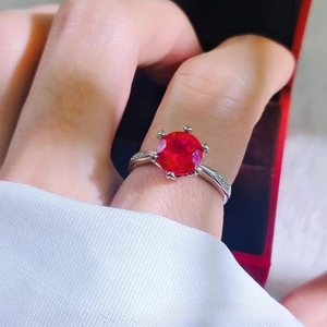 Detailed view of a silver ring featuring a 2-carat round ruby in a six-prong setting