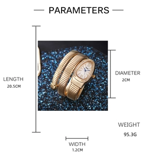 Detailed view of golden snake-shaped bracelet watch with crystal bezel and blue backdrop