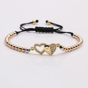 Adjustable woven bracelet with triple-tone beads and double heart cubic zirconia accents