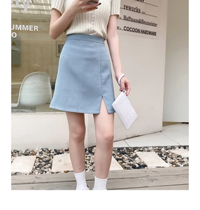 Detail of light blue high-waist A-line skirt with side slit and smooth fabric texture