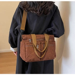Detailed back view of a brown corduroy crossbody bag with adjustable straps and pockets
