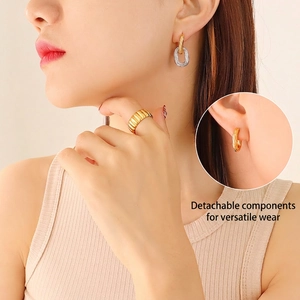 Two-tone chain earrings and textured gold ring shown on model with detachable feature
