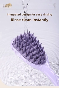 Water rinsing a silicone shampoo brush showing easy clean cone-shaped bristles
