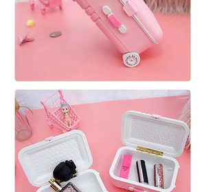 Miniature pink luggage storage box showing extendable handle and interior makeup organizer