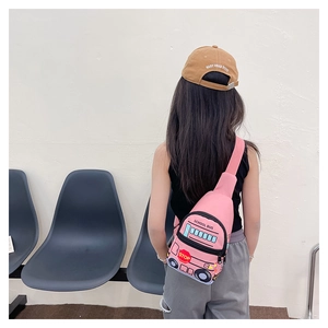 Pink school bus shaped kids chest bag shown on a young model for size reference